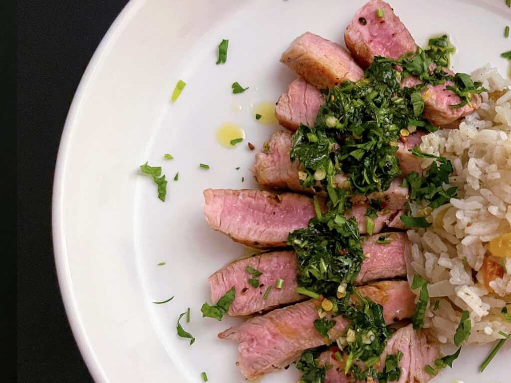 Sautéed Pork Loin with Lemon Mint Chimichurri and Sultana Cardamom Jasmine Rice